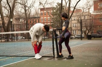 fitness recovery gear - man in white long sleeve shirt and red pants playing basketball during daytime