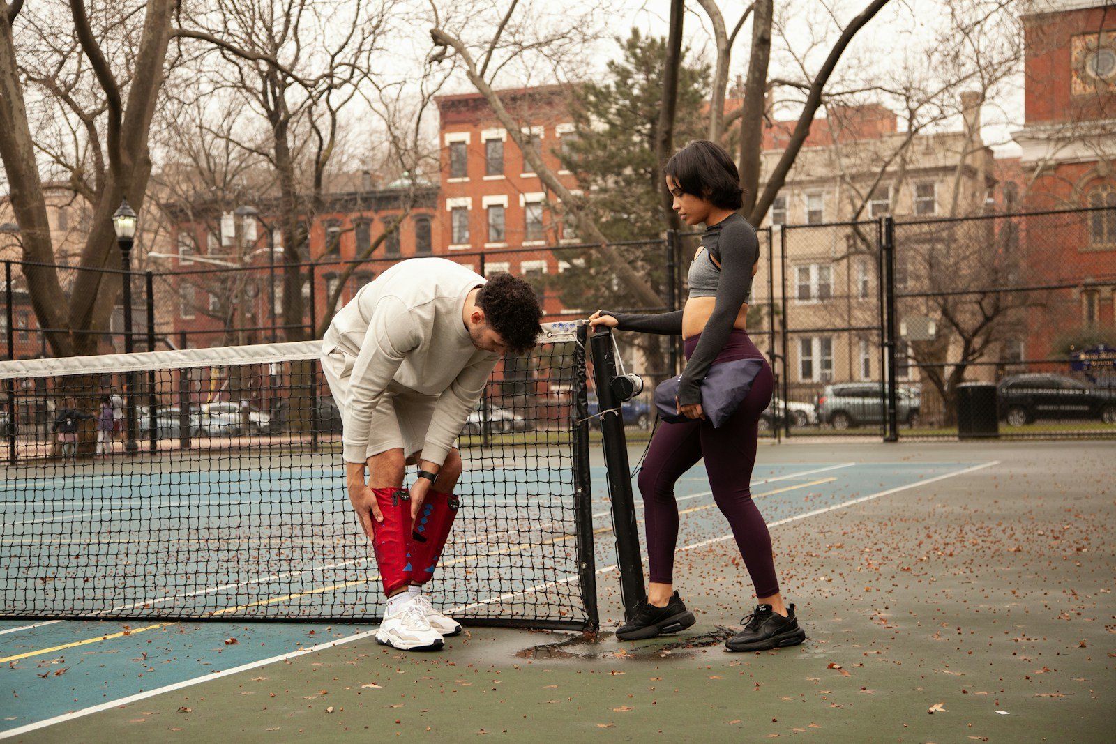 fitness recovery gear - man in white long sleeve shirt and red pants playing basketball during daytime