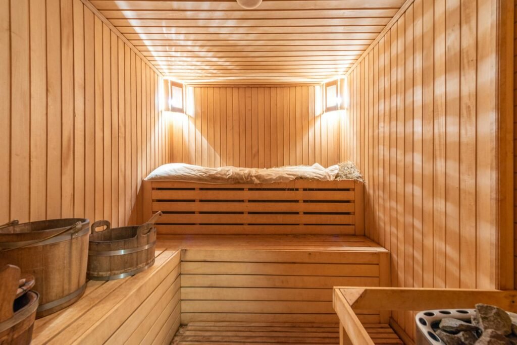 Fitness Recovery Gear: What You Need and Why 4 Warm and inviting wooden sauna with ambient lighting, perfect for relaxation.