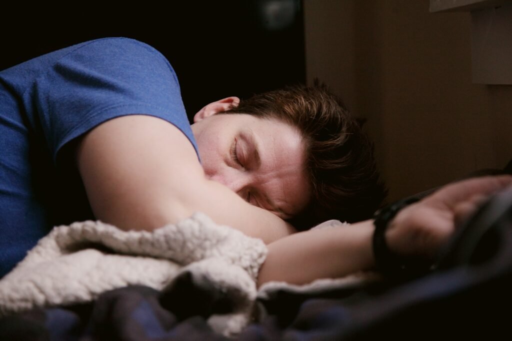 Unlock Your Strength: Optimizing Post-Workout Recovery 4 woman in blue shirt lying on bed