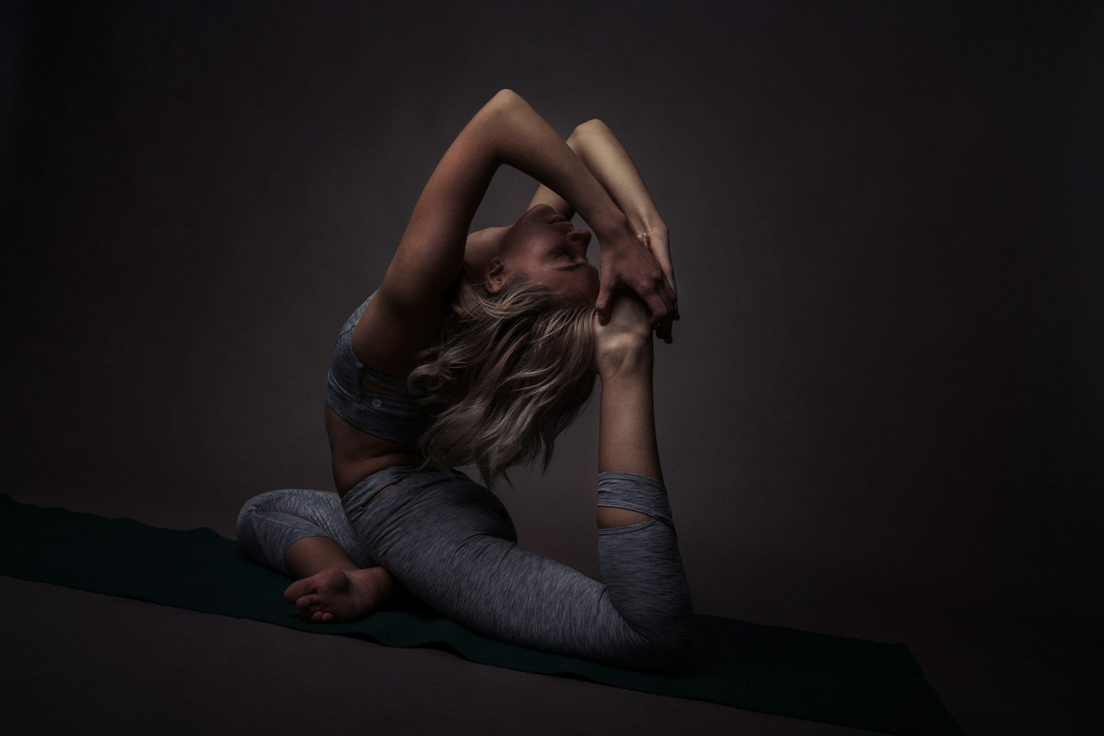Best Stretching Tools for Flexibility: Top Picks for Optimal Mobility 1 Best Stretching Tools: woman in blue denim jeans lying on black floor